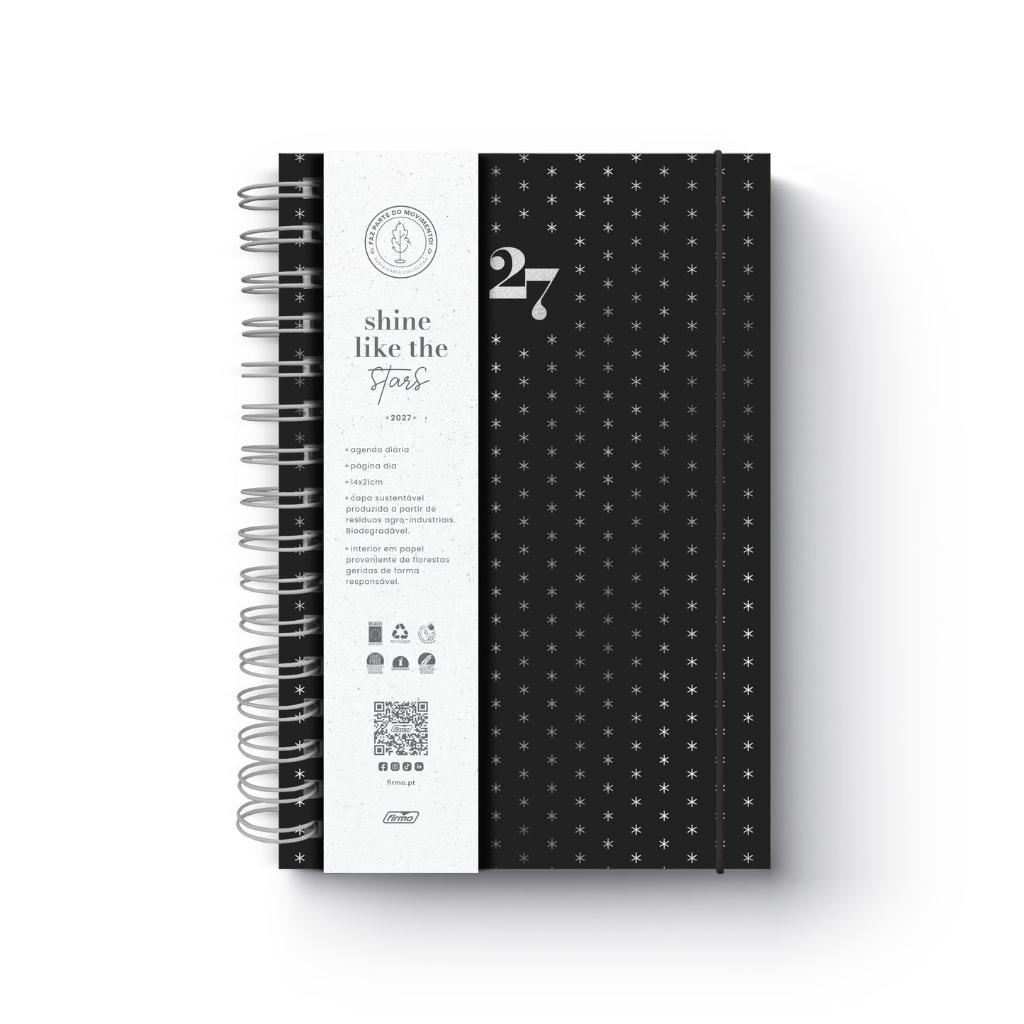 Agenda diária de 2027 Eco Skye da Firmo, em preto com padrão de pequenas estrelas prateadas, encadernação em espiral e uma faixa protetora branca com o texto "shine like the stars", sobre fundo neutro.