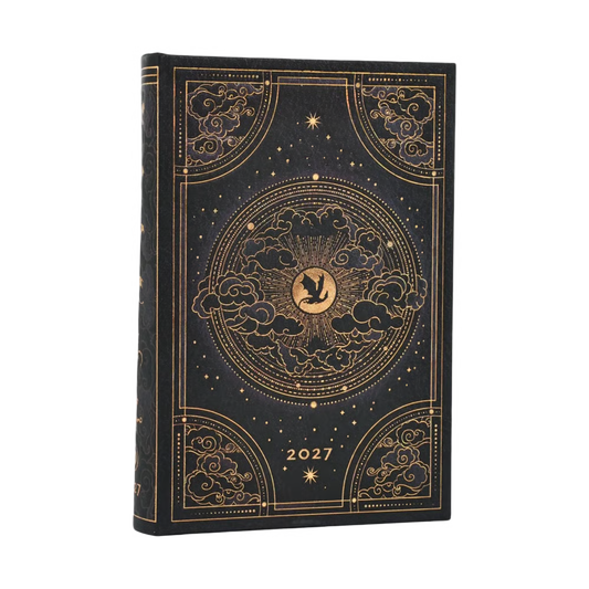 Agenda de capa preta com ilustração dourada e emblema central, “2027”, e nuvens